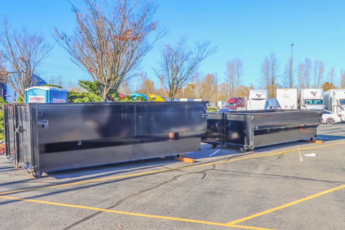 Professional dumpster rental service with roll-off container on residential driveway in Prairie du Chien